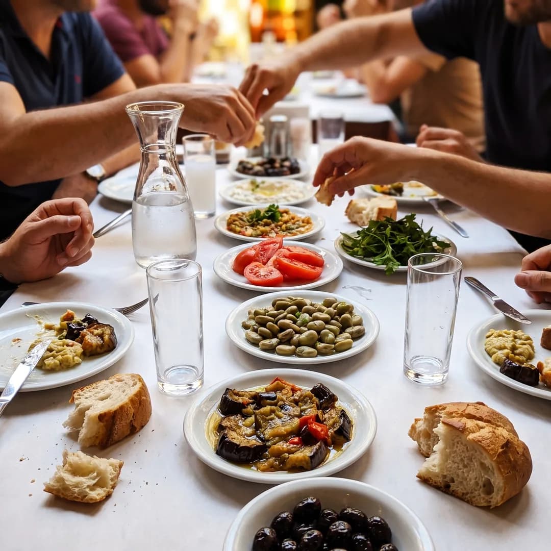 Meyhane masasında mezeler, ekmek ve bardaklar